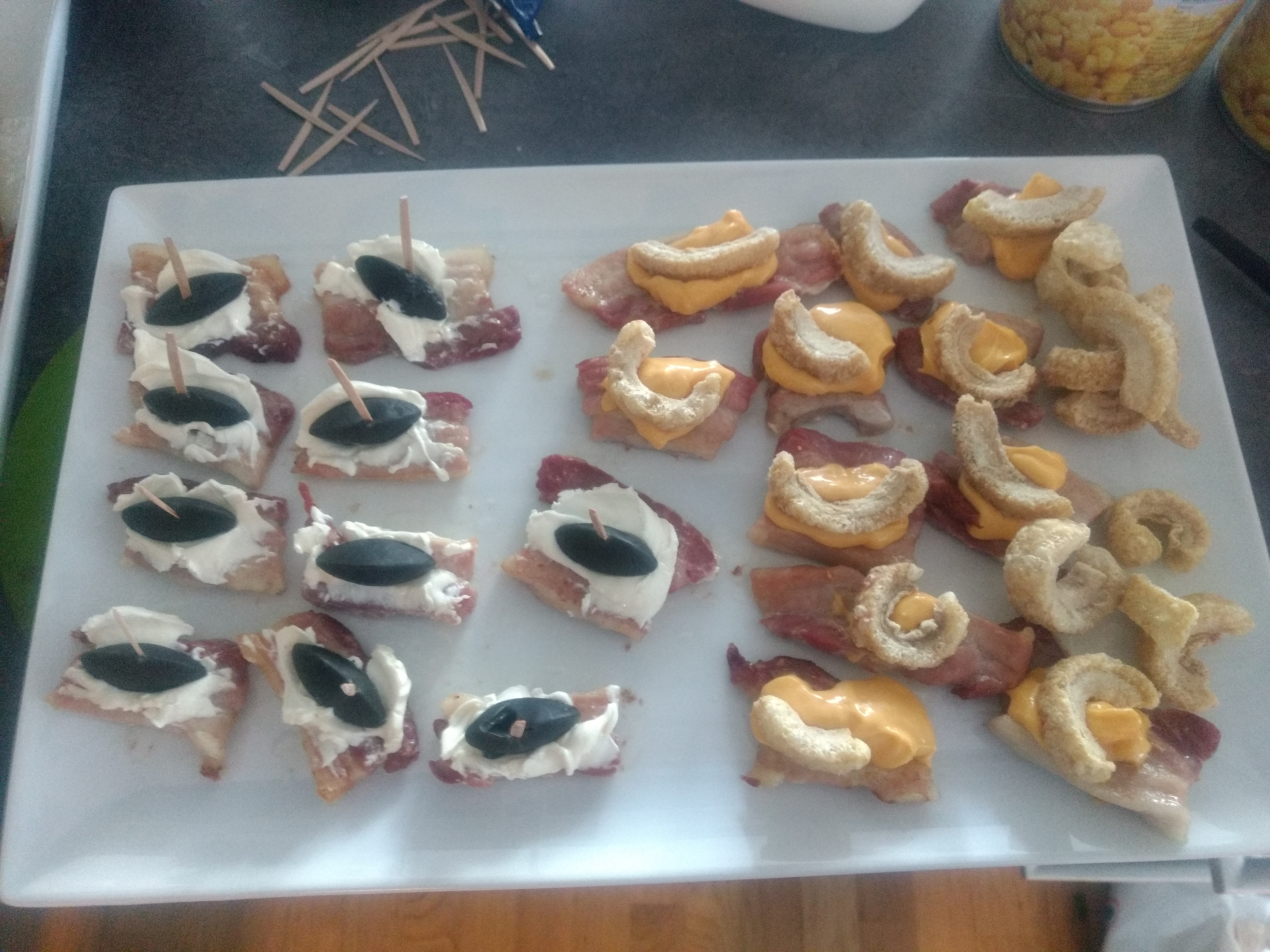 Bacon canapee, cream cheese and liquorice boat and cheese dip and bacon crisp